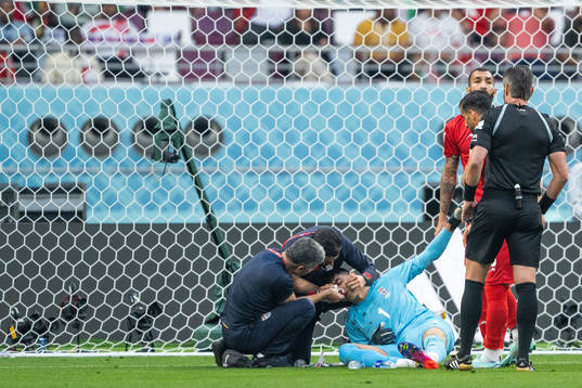 Goalkeeper Alireza Beiranvand of Iran receives medical