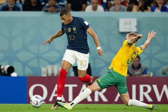 Kylian Mbappe of France and Nathaniel Atkinson of Australia