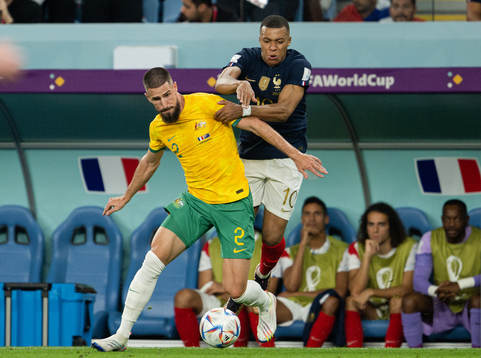 Milos Degenek of Australia and Kylian Mbappe of France