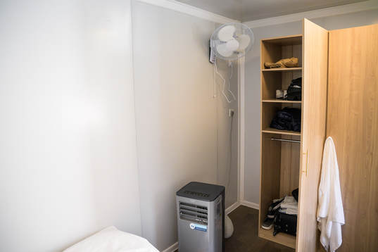 A fan and air cooling device in a room at Fan Village