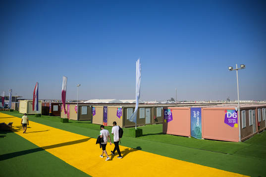 People walk between containers at Fan Village Cabins Free