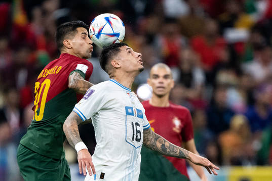Joao Cancelo of Portugal and Mathias Olivera of Uruguay