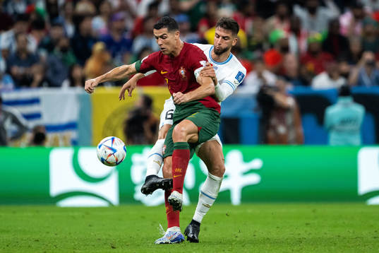 Rodrigo Bentancur of Uruguay and Cristiano Ronaldo of