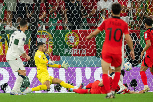 Younggwon Kim of South Korea scores the 1-1 goal behind
