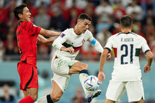 Wooyoung Jung of South Korea and Cristiano Ronaldo of