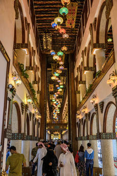 Visitors walk through Souq Waqif Art Center