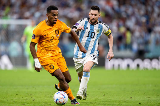 Jurrien Timber of Netherlands and Lionel Messi of Argentina