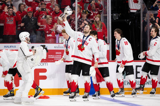 Shane Wright of Canada celebrates with the trophy