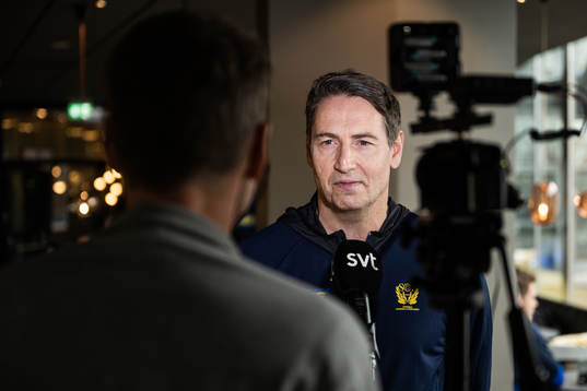 Head coach Glenn Solberg is interviewed at a press event