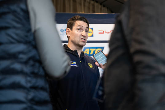 Head coach Glenn Solberg is interviewed at a press event