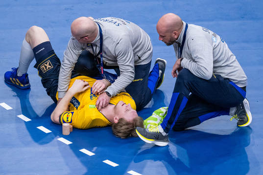 Eric Johansson of Sweden receives medical attention from