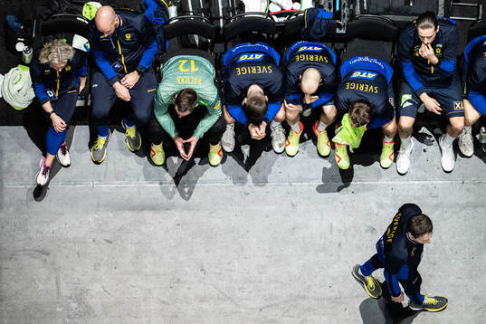 Players and Head coach Glenn Solberg look dejected