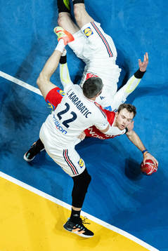 Mathias Gidsel of Denmark and Luka Karabatic of France