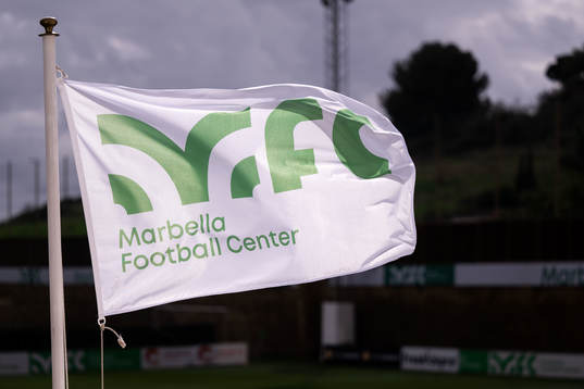Flags with the Marbella Football Center logo