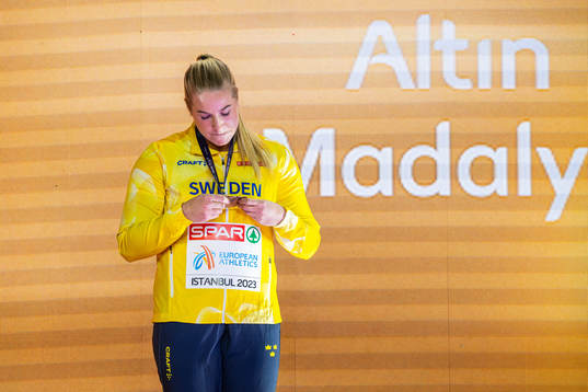 Fanny Roos of Sweden looks at her bronze medal at the medal