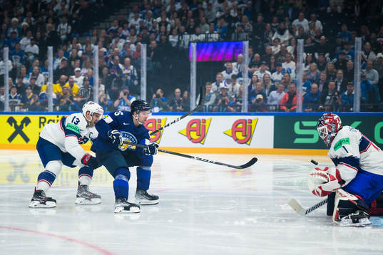 Nick Bonino and goaltender Casey Desmith of USA are being