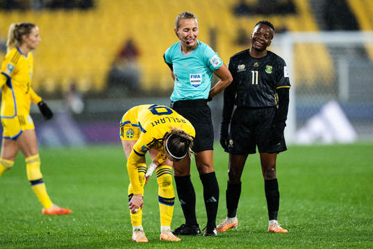 Kosovare Asllani of Sweden, referee Ekaterina Koroleva and