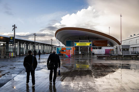 People walk past the FIFA Fan Zone