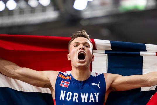 Karsten Warholm of Norway (gold) celebrates