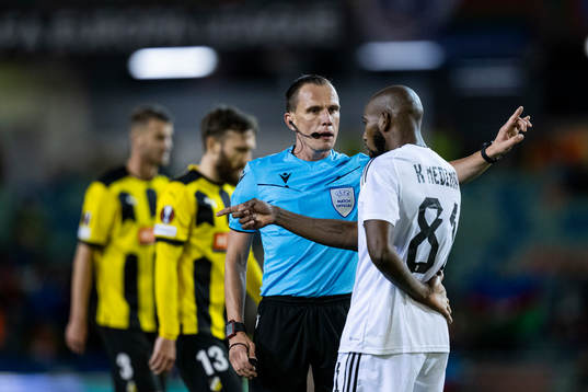 Referee Sebastian Gishamer and Kevin Medina of Qarabag