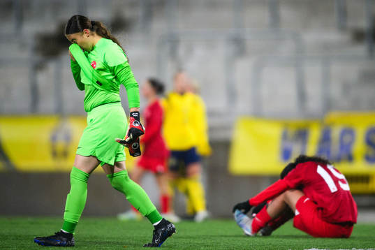 Goalkeeper Defne Sarioglu and Nihal Sarac of Turkey look