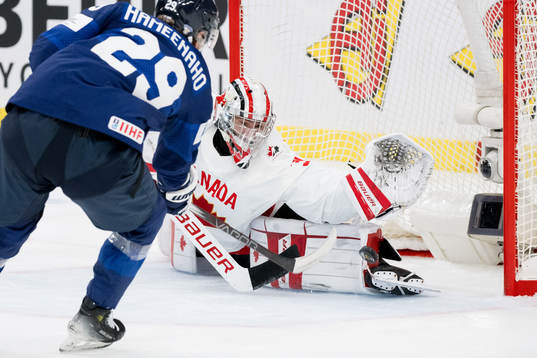 Goaltender Mathis Rousseau of Canada with a save