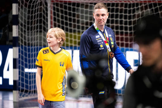 Goalkeeper Andreas Palicka of Sweden with his son