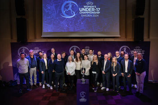Representatives pose for a picture with the trophy