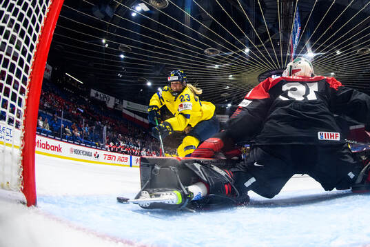 Thea Johansson of Sweden scores 4-2 behind goaltender Riko
