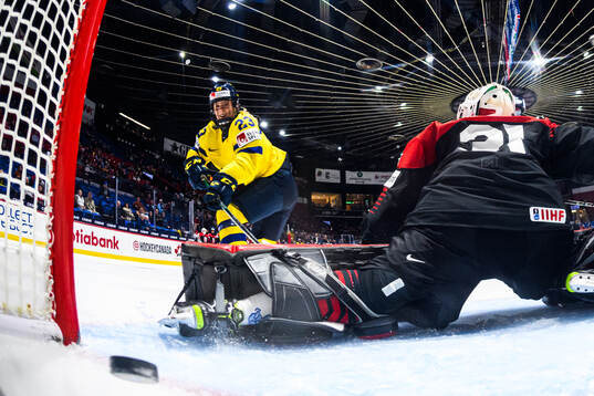 Thea Johansson of Sweden scores 4-2 behind goaltender Riko