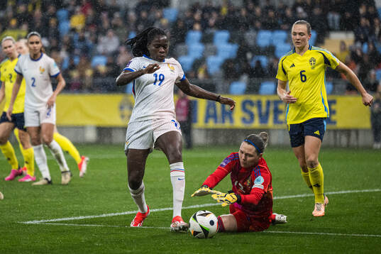 Griedge Mbock Bathy of France and goalkeeper Jennifer Falk