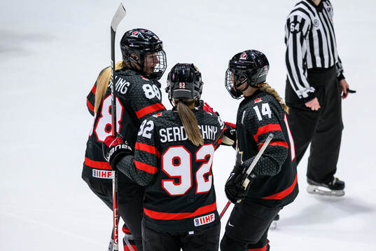 Renata Fast of Canada celebrates with teammates