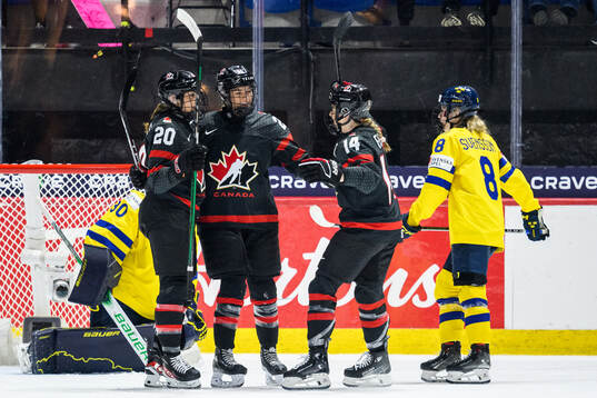 Natalie Spooner of Canada celebrates with Sarah Nurse and
