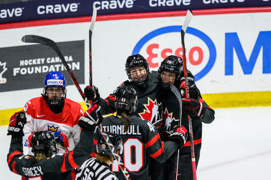Jocelyne Larocque of Canada celebrates with teammates