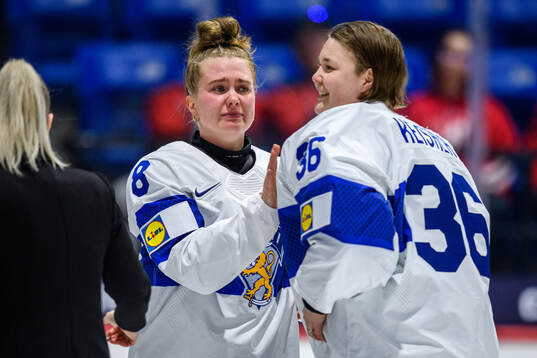 Eve Savander and goaltender Anni Keisala of Finland