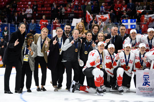 Players and staff of Canada celebrate