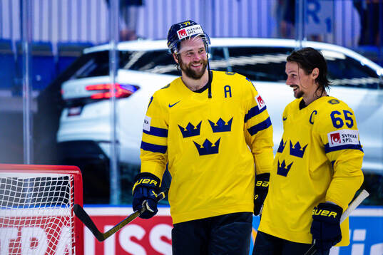 Victor Hedman and Erik Karlsson of Sweden celebrate