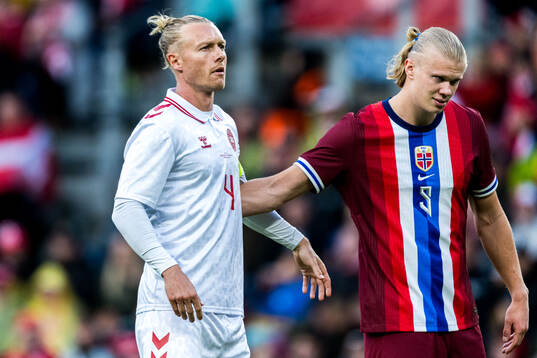 Simon Kjær of Denmark and Erling Braut Haaland of Norway