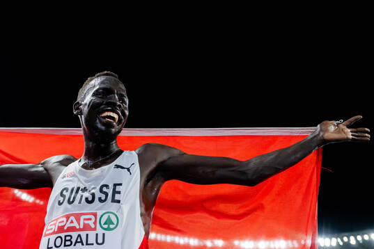 Dominic Lokinyomo Lobalu of Switzerland celebrates
