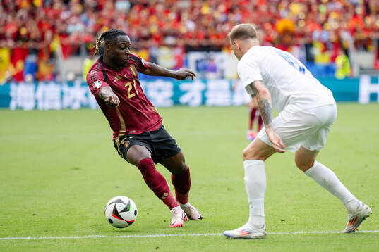 Jeremy Doku of Belgium and Ondrej Duda of Slovakia