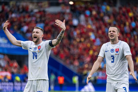 Milan Skriniar and Denis Vavro of Slovakia celebrate