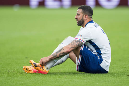 Kyle Walker of England changes shoes
