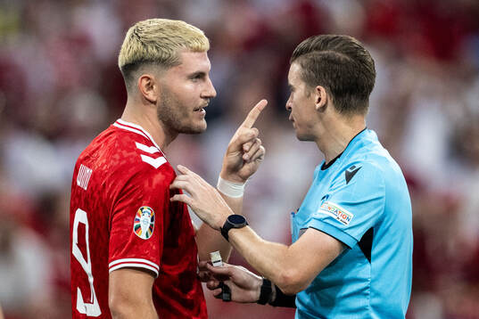 Jonas Wind of Denmark reacts against referee François