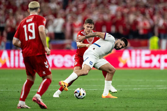 Jannik Vestergaard of Denmark and Aleksandar Mitrovic of