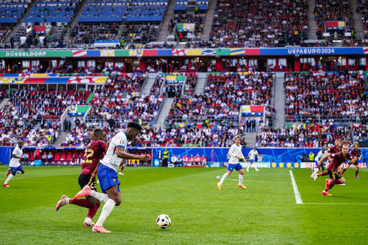 Jeremy Doku of Belgium and Aurélien Tchouameni of France