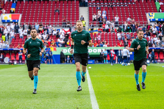 Assistant referee Mahbod Beigi, referee Glenn Nyberg and