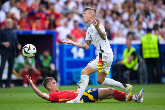Toni Kroos of Germany and Daniel Olmo of Spain