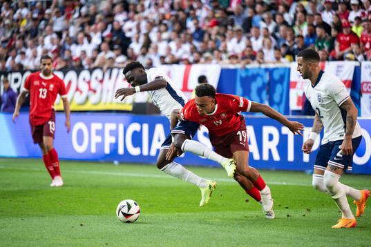 Bukayo Saka of England and Dan Ndoye of Switzerland