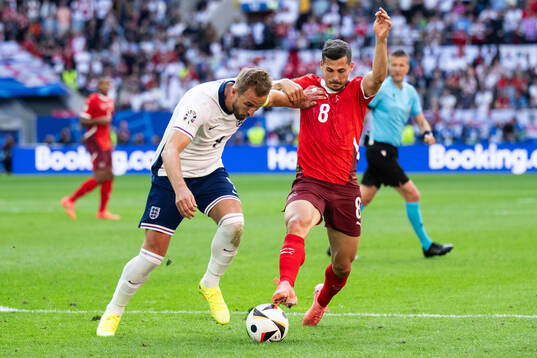 Harry Kane of England and Remo Freuler of Switzerland