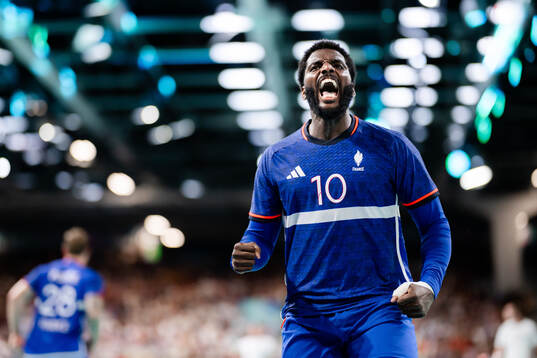Dika Mem of France celebrates in a men's preliminary round
